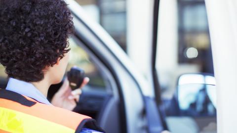 Emergency medical services personnel speaking into radio.